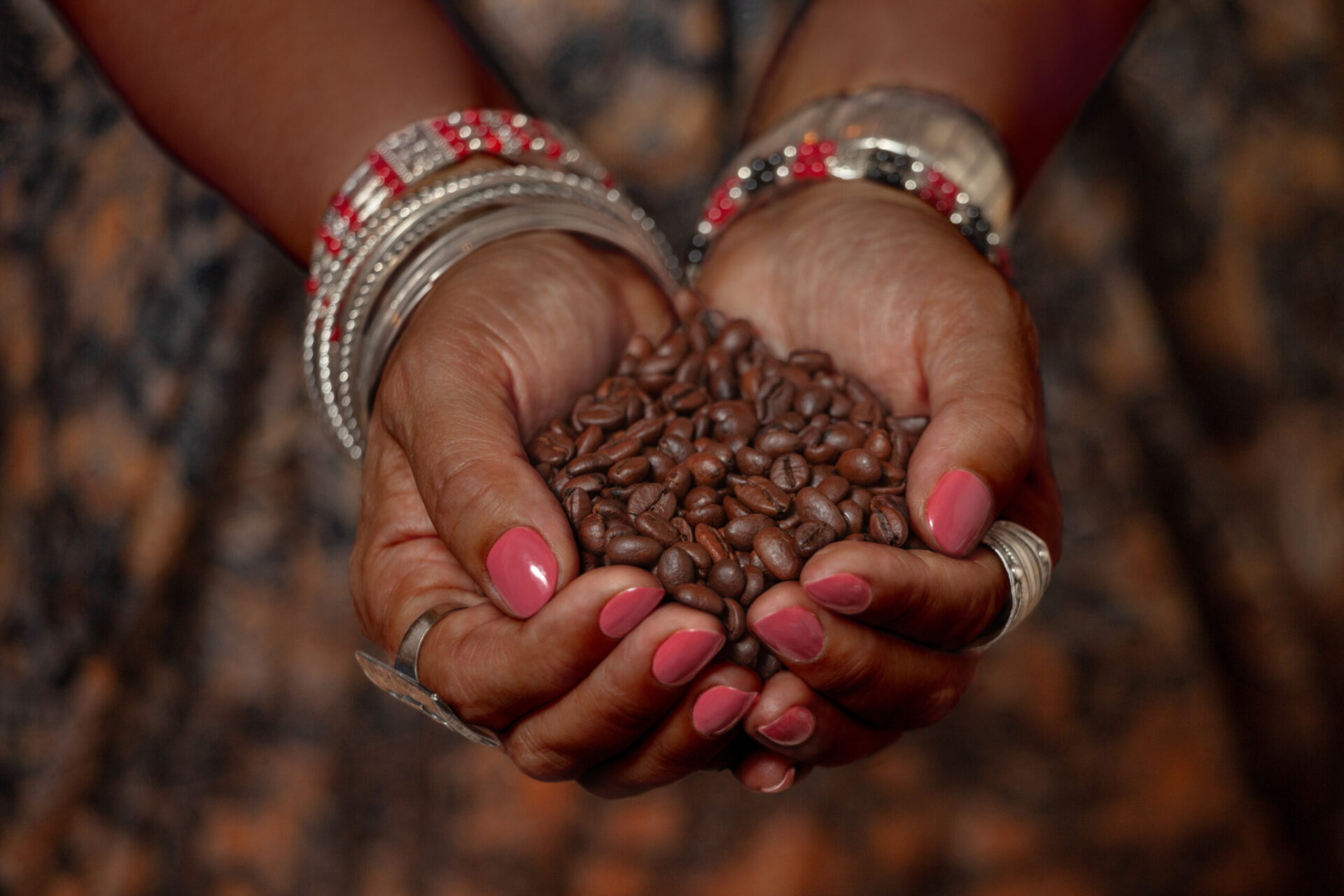Woman holding coffee beans for Fairtrade Fortnight